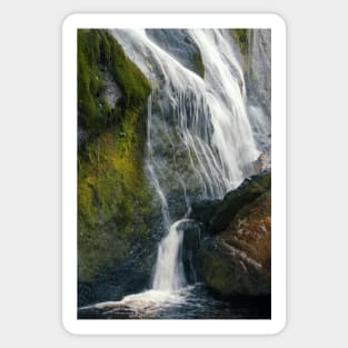 A beautiful waterfall cascades down a mountain in Ireland. Sticker